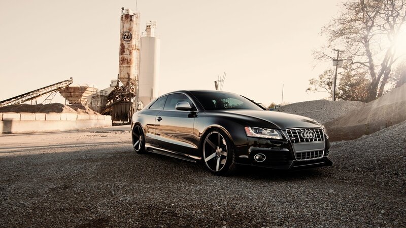 Black Audi parked at industrial site