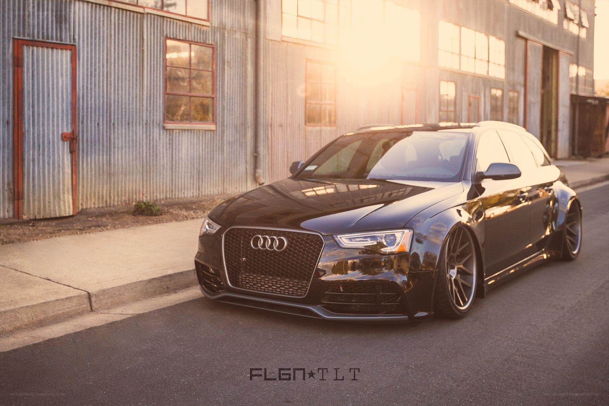 Black Audi parked at sunset