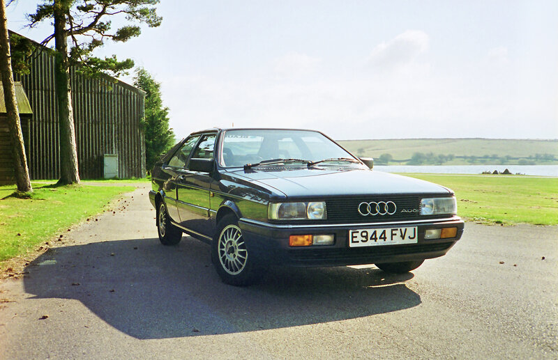 Black Audi parked by a lake