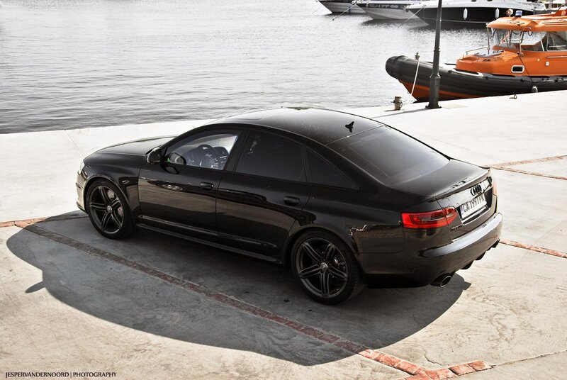 Black Audi parked by the water