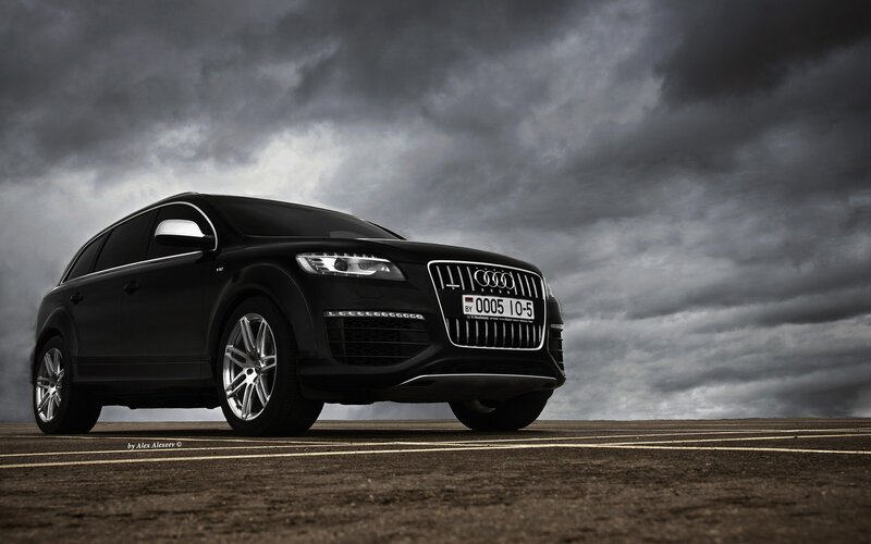 Black Audi Q7 under stormy sky