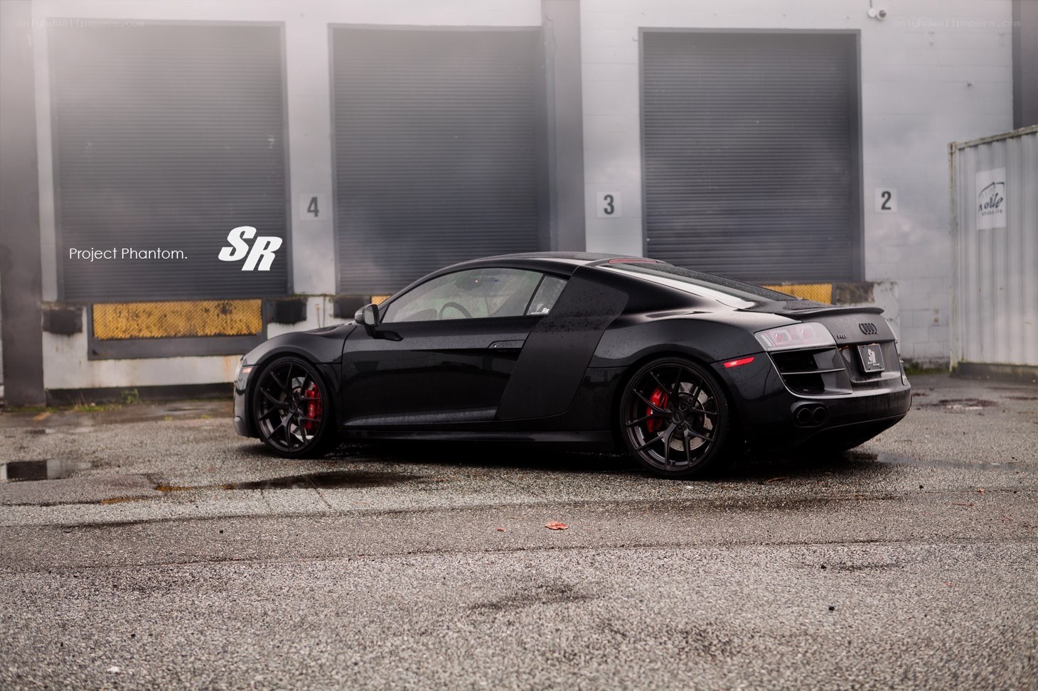 Black Audi R8 in industrial setting