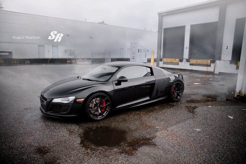 Black Audi R8 on wet pavement