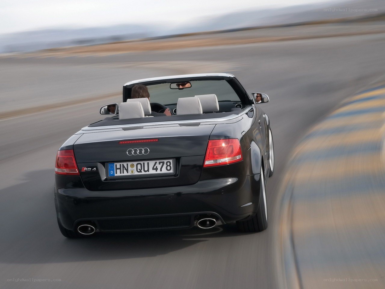 Black Audi RS4 convertible in motion