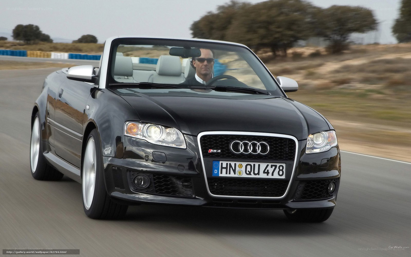Black Audi RS4 convertible in motion