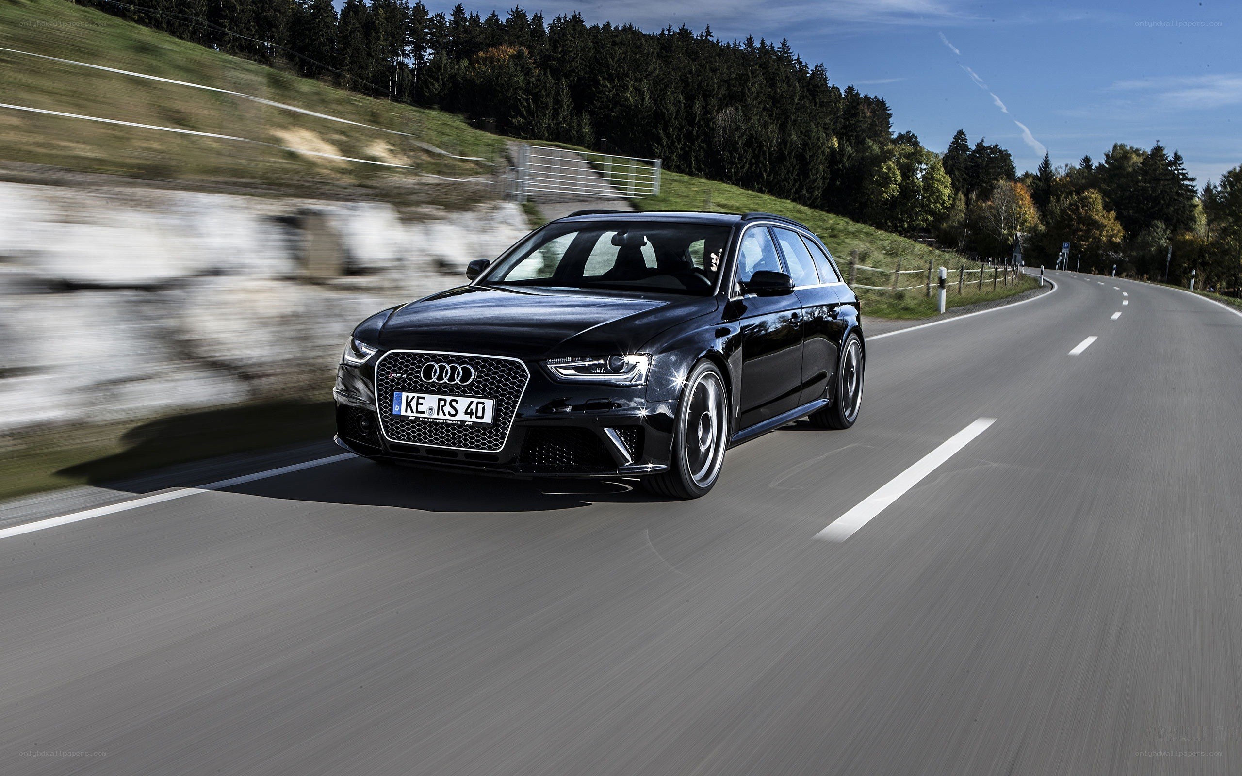 Black Audi RS4 driving on a road