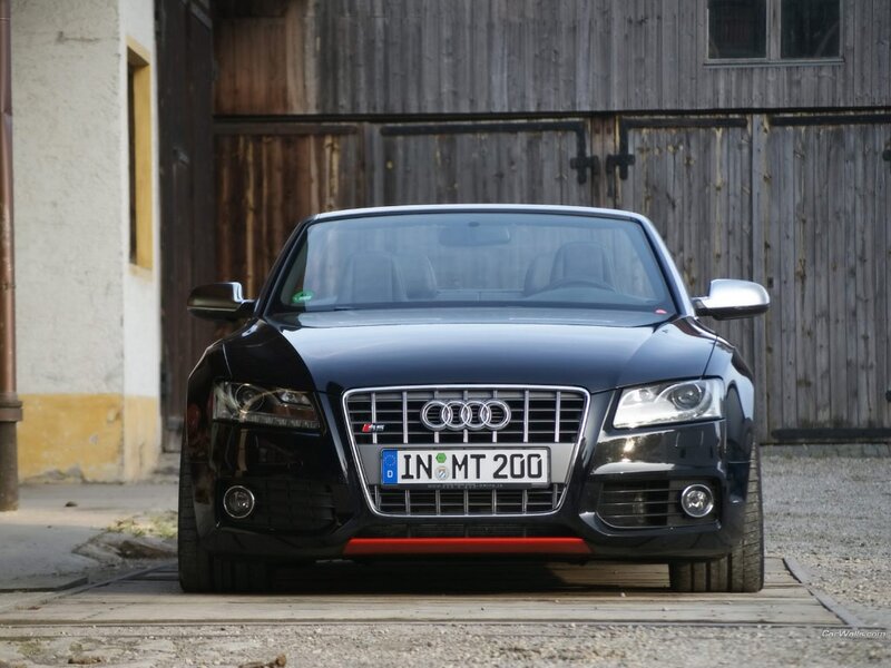 black audi rs5 parked in front of barn