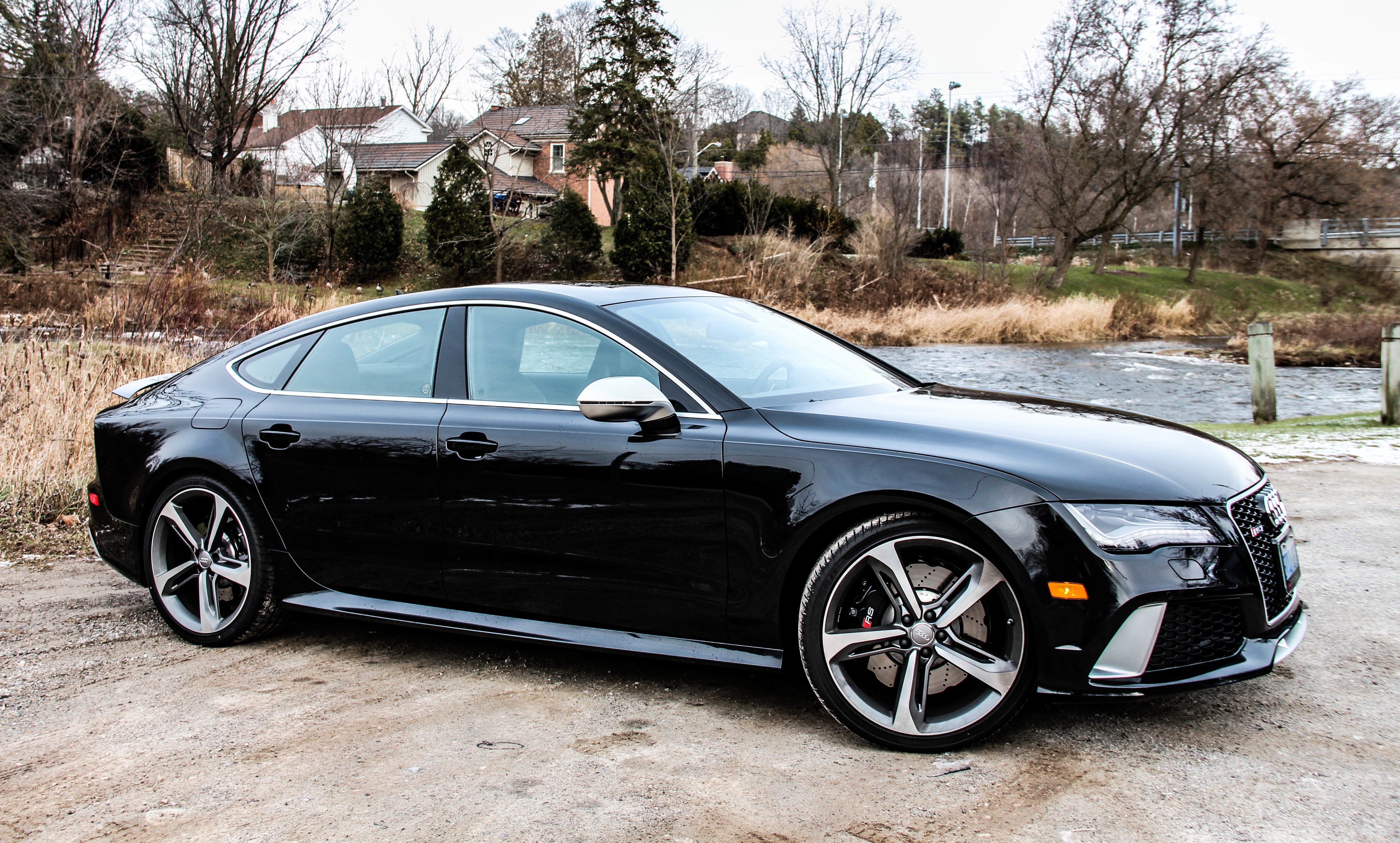 Black Audi RS7 parked by river