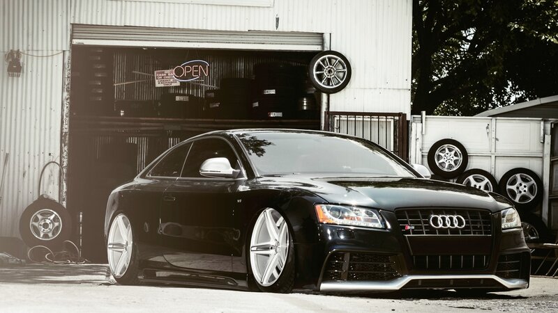 Black Audi S5 in front of garage