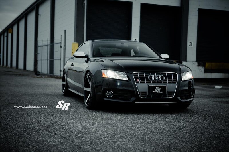 Black Audi S5 in front of warehouse
