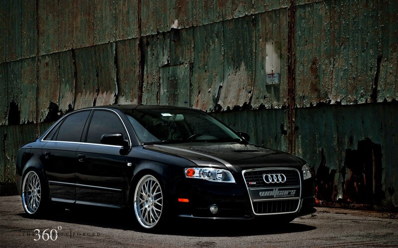 Black Audi sedan in industrial setting