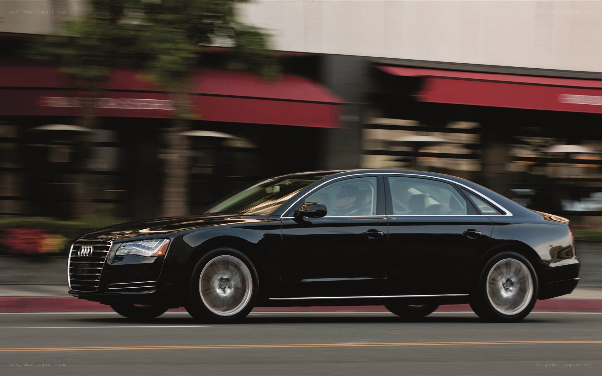 Black Audi sedan in motion