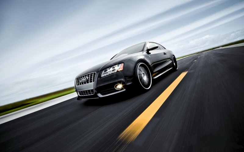 Black Audi speeding on road