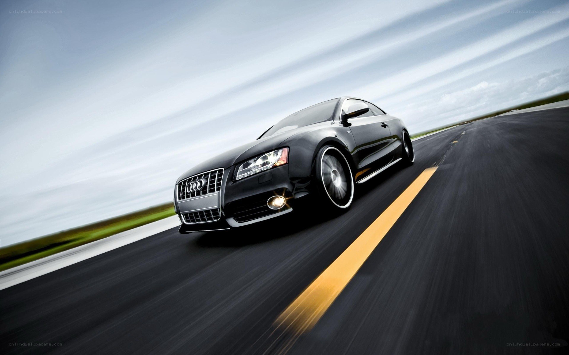 Black Audi speeding on road