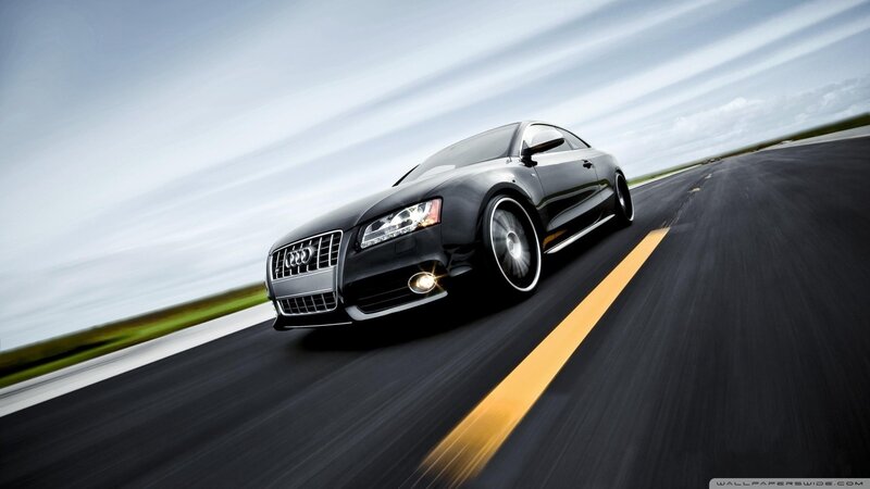 Black Audi speeding on road