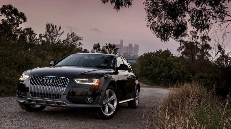 Black Audi station wagon on gravel path