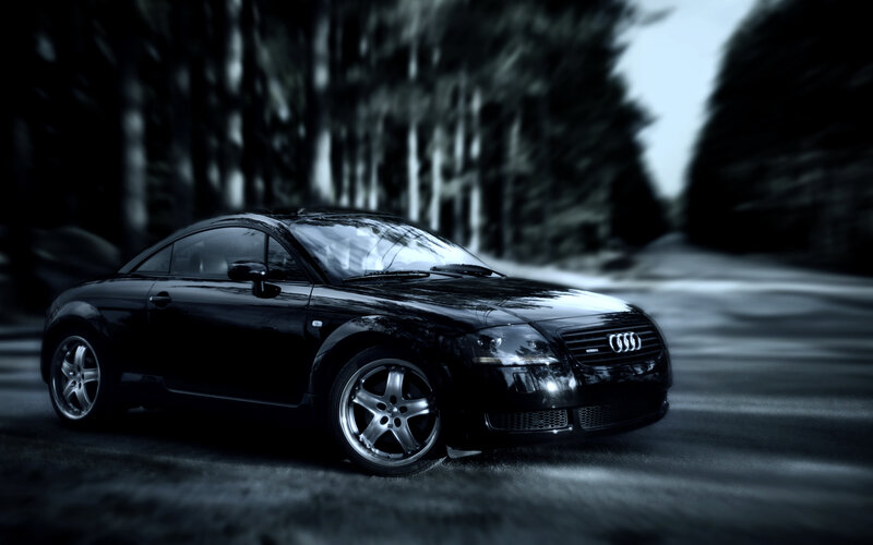 black audi tt on forest road