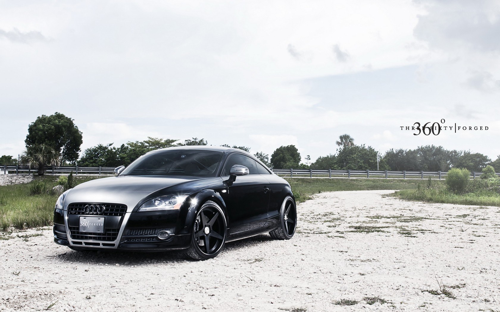 Black Audi TT on gravel