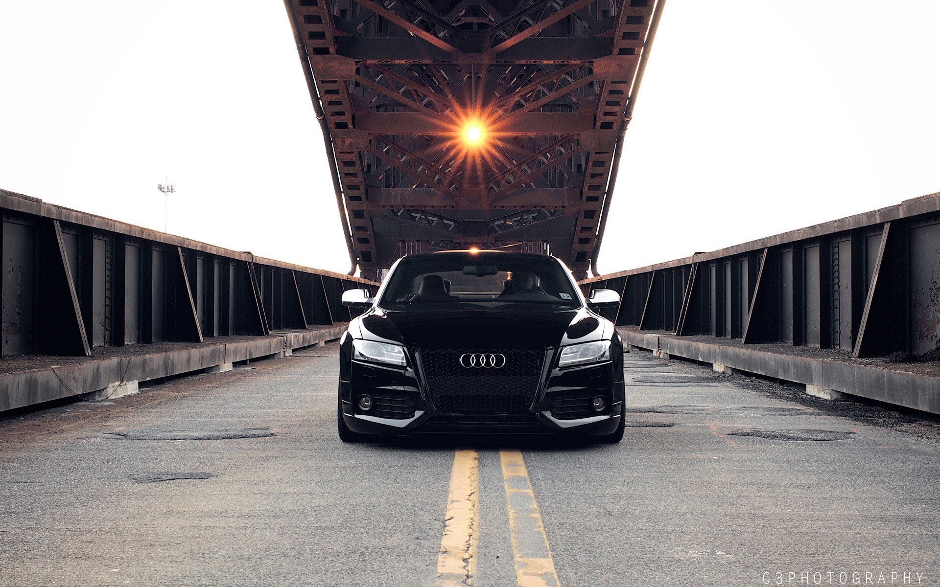 Black Audi under a bridge