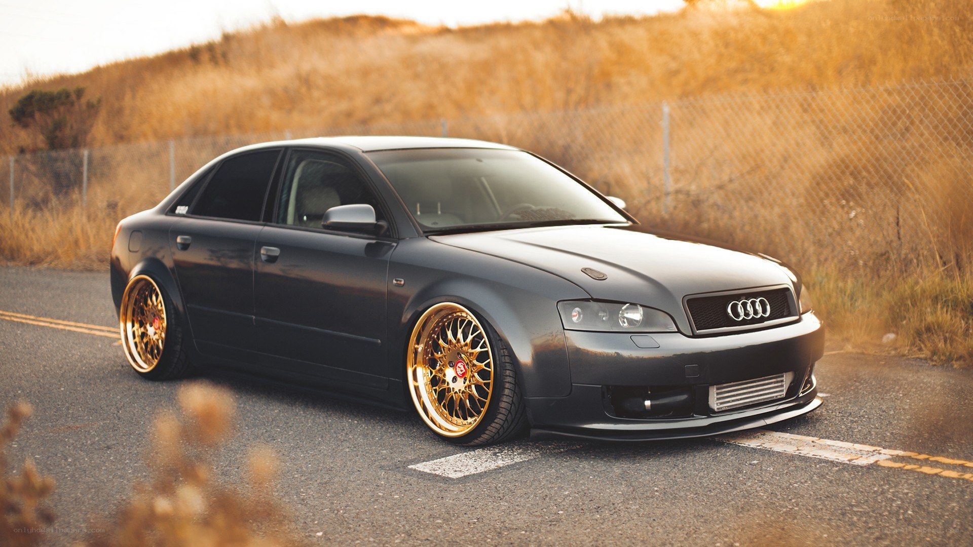 black audi with gold wheels