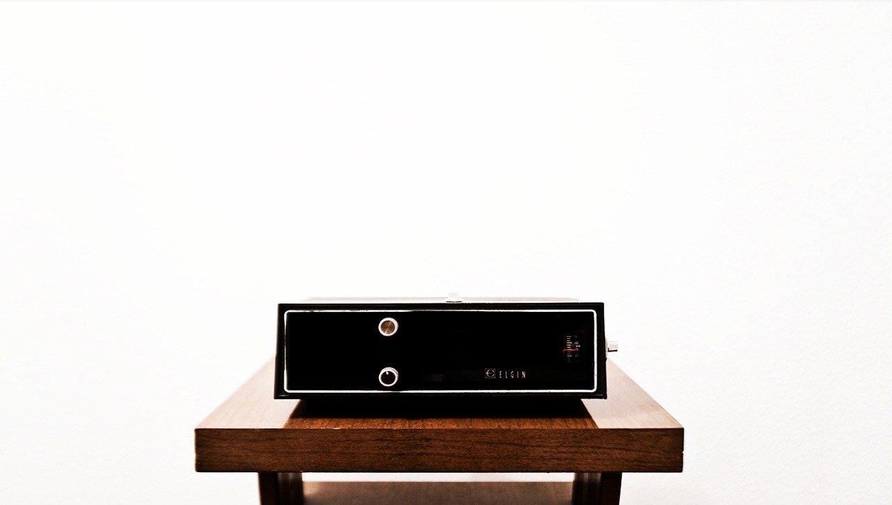 black audio device on wooden table