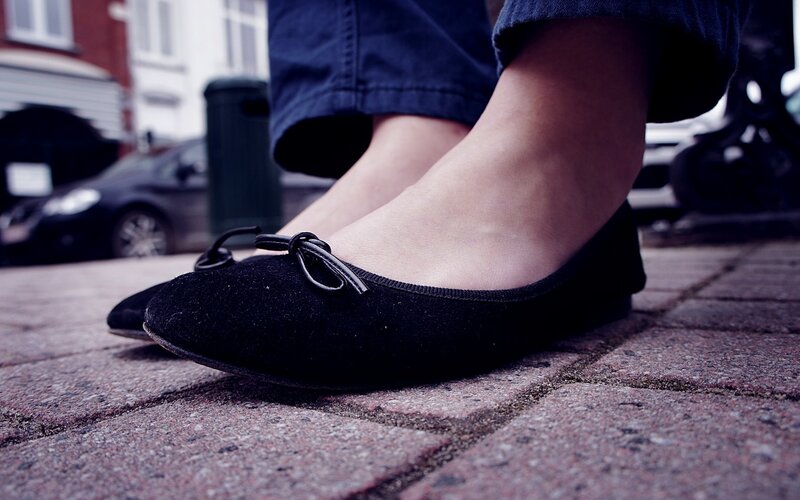 black ballet flats on pavement