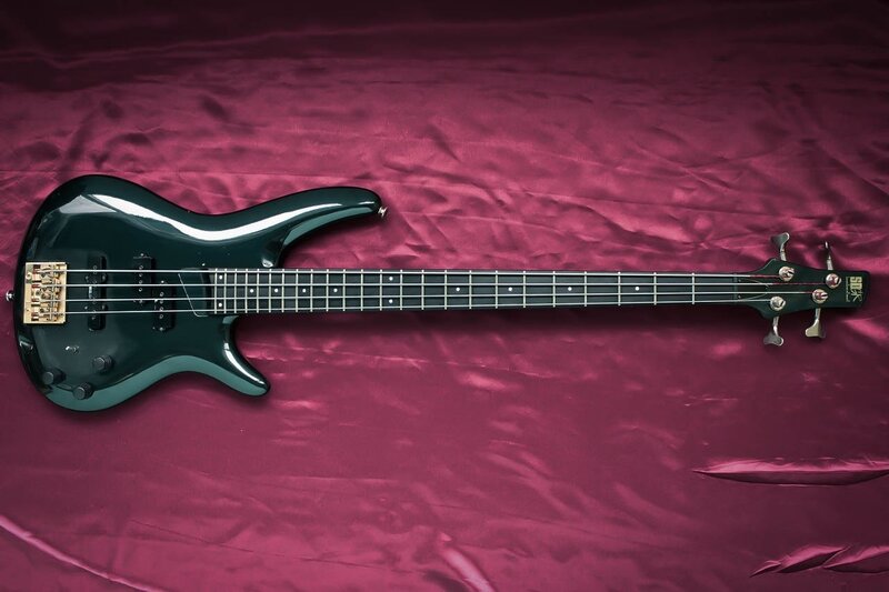 black bass guitar on purple cloth
