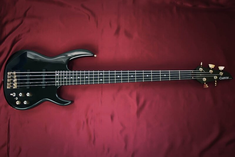 black bass guitar on red cloth