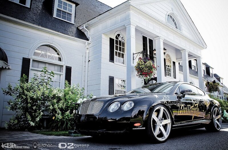 Black Bentley in front of a house