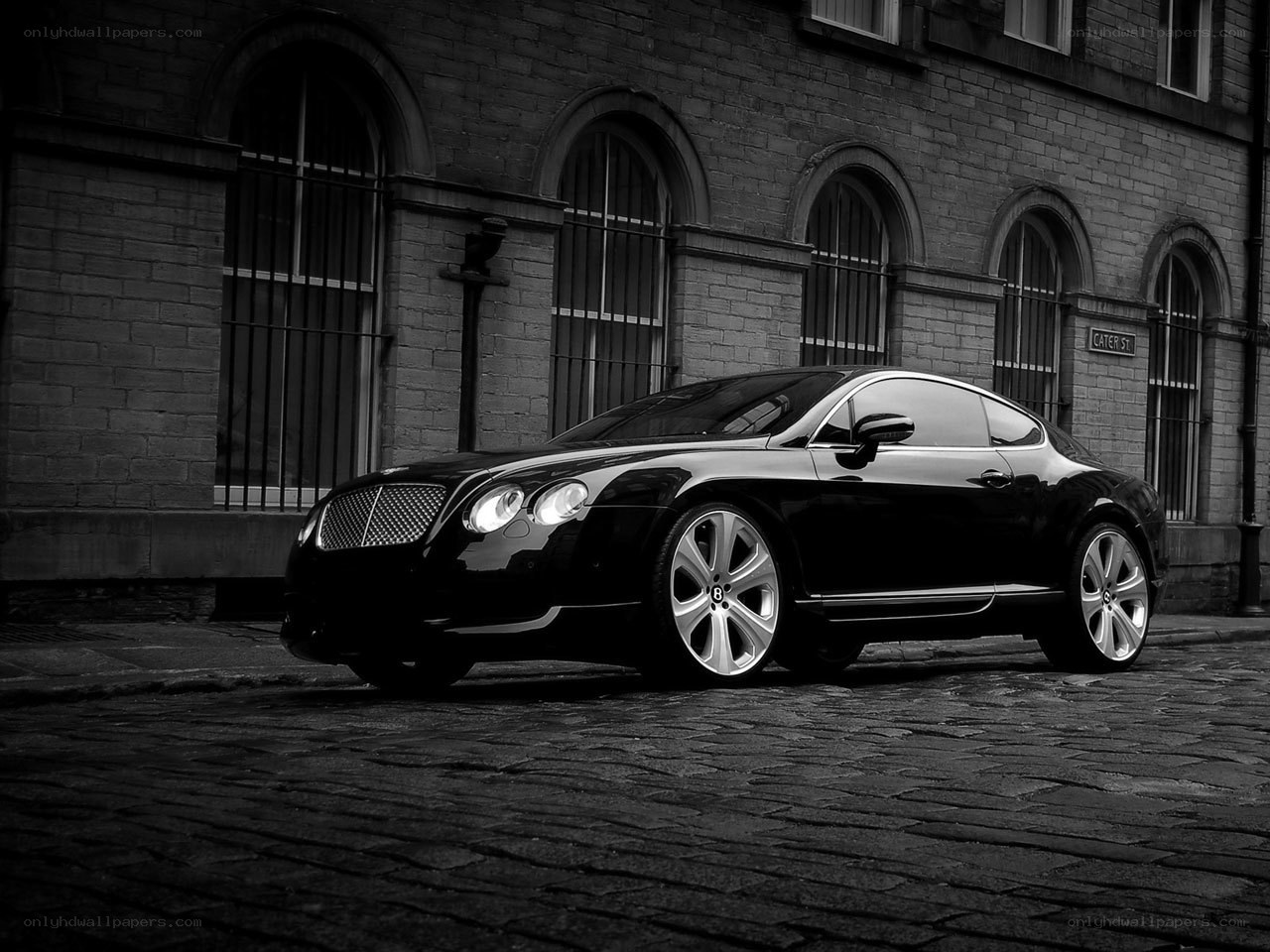 Black Bentley on cobblestone street