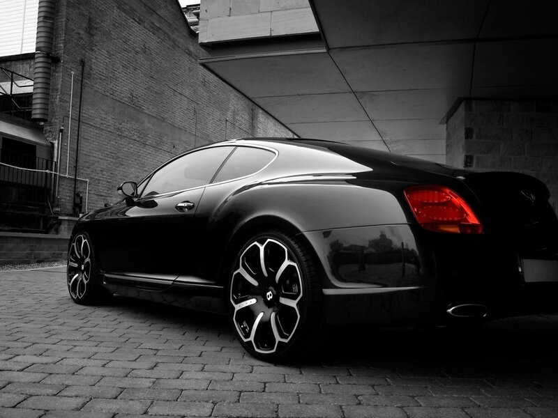 Black Bentley parked in alley