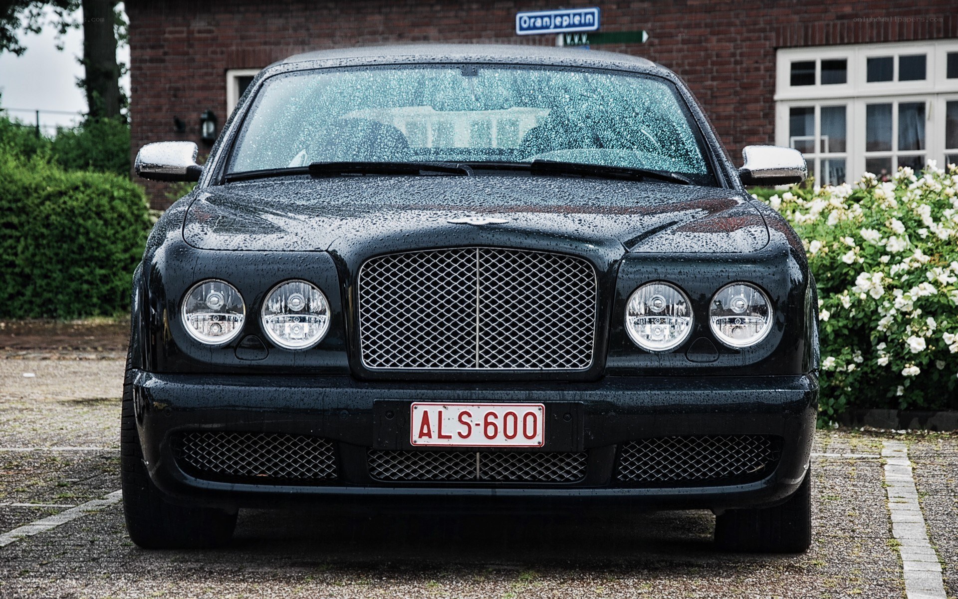 Black Bentley parked in rain