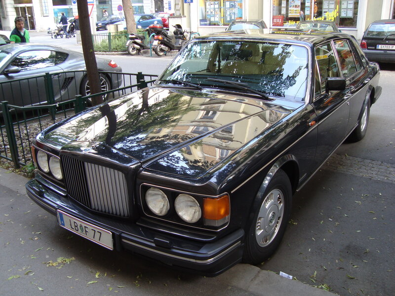 Black Bentley parked on a street