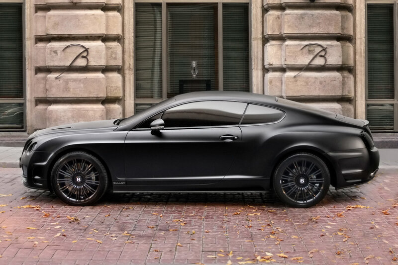 Black Bentley parked on cobblestones