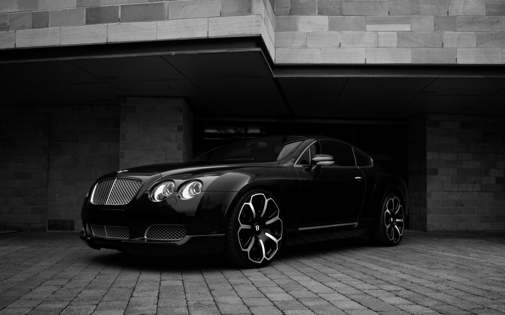 Black Bentley parked under a building
