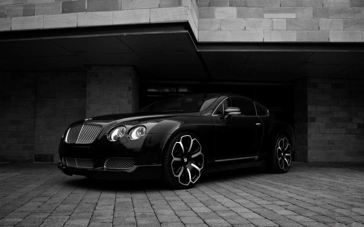 Black Bentley parked under a building