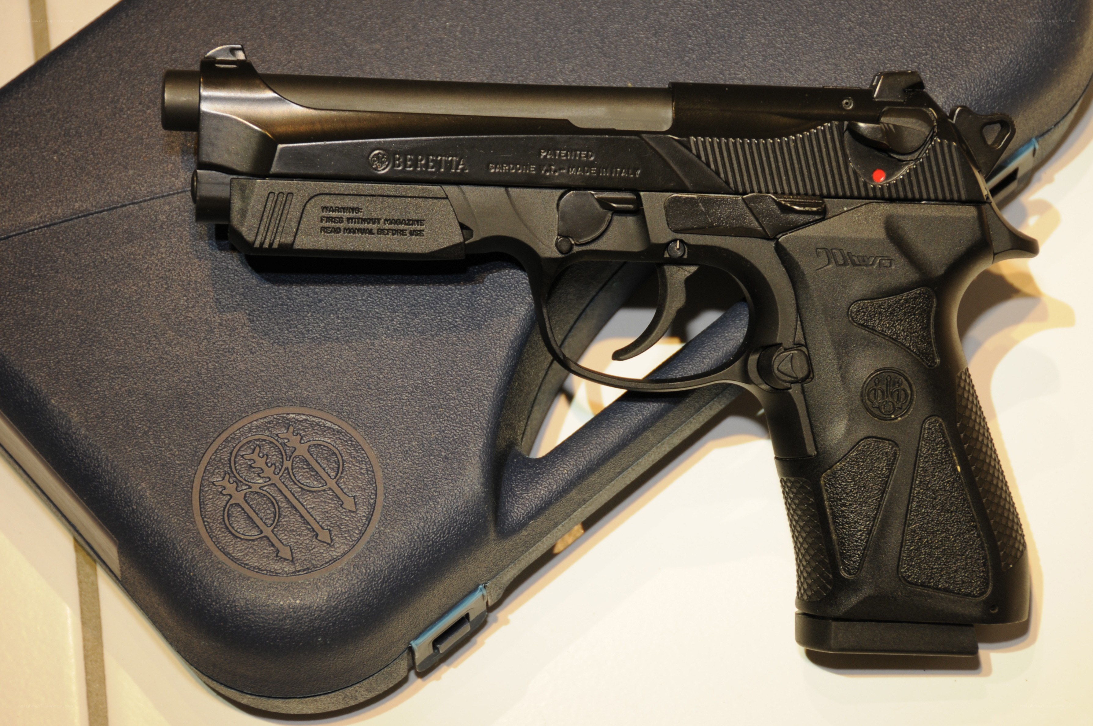Black Beretta handgun on case