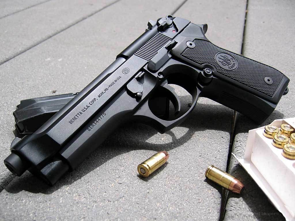 Black Beretta pistol with ammunition