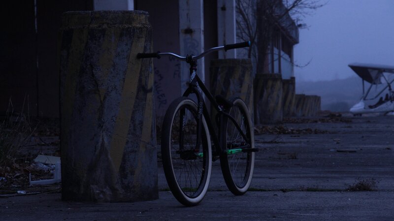 Black Bicycle Against Pillar