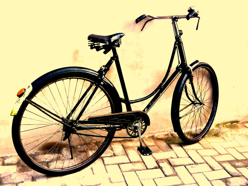 black bicycle against wall