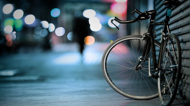 Black Bicycle on Sidewalk — Blue
