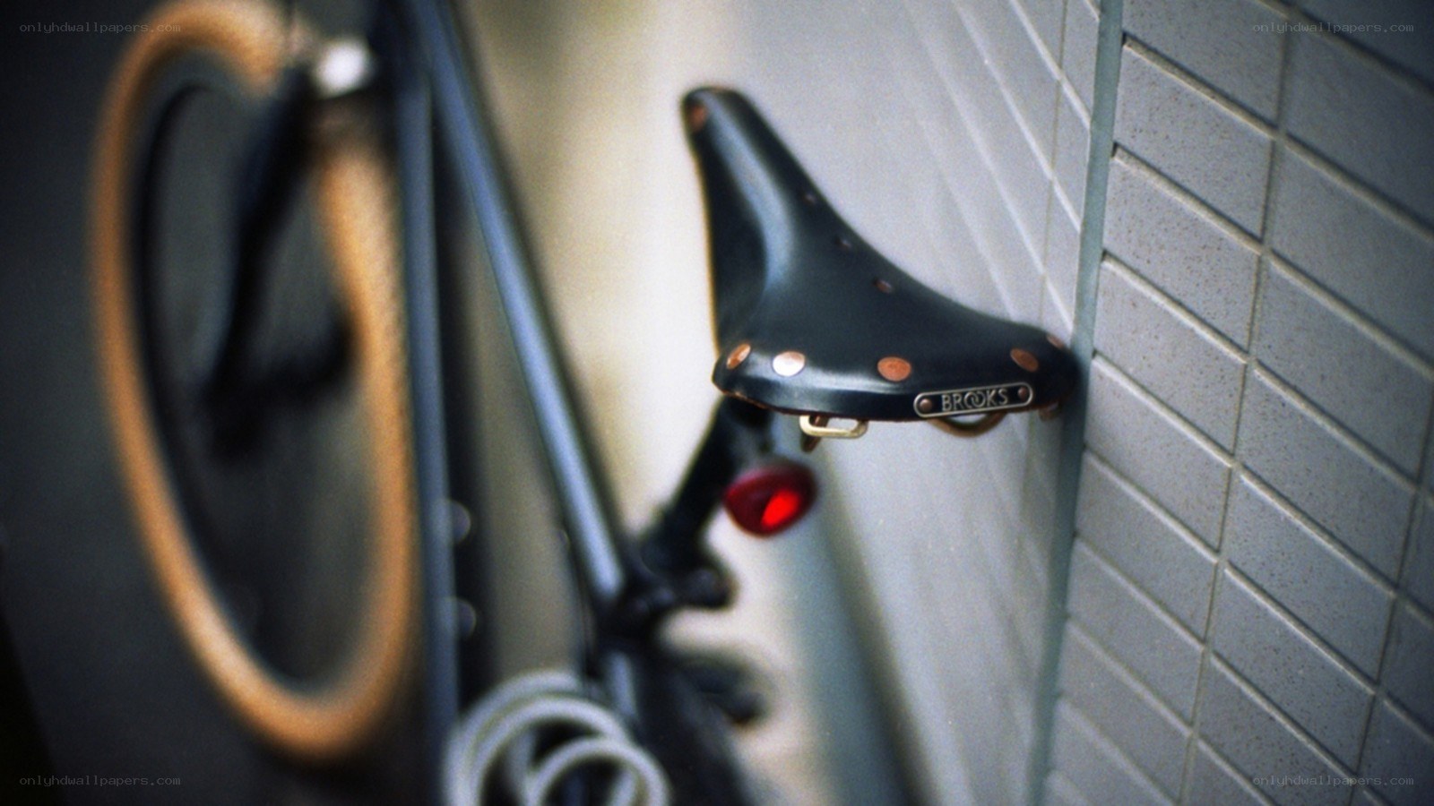black bicycle seat against wall