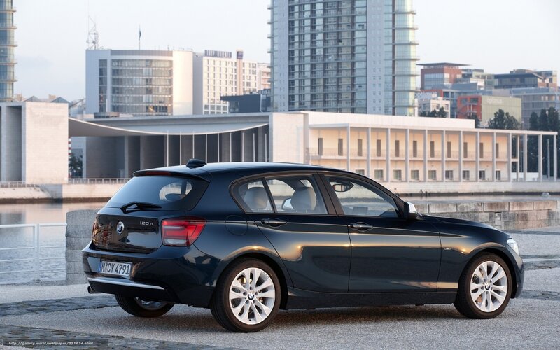 Black BMW 120d parked by water