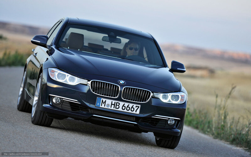 Black BMW 3 Series driving on road
