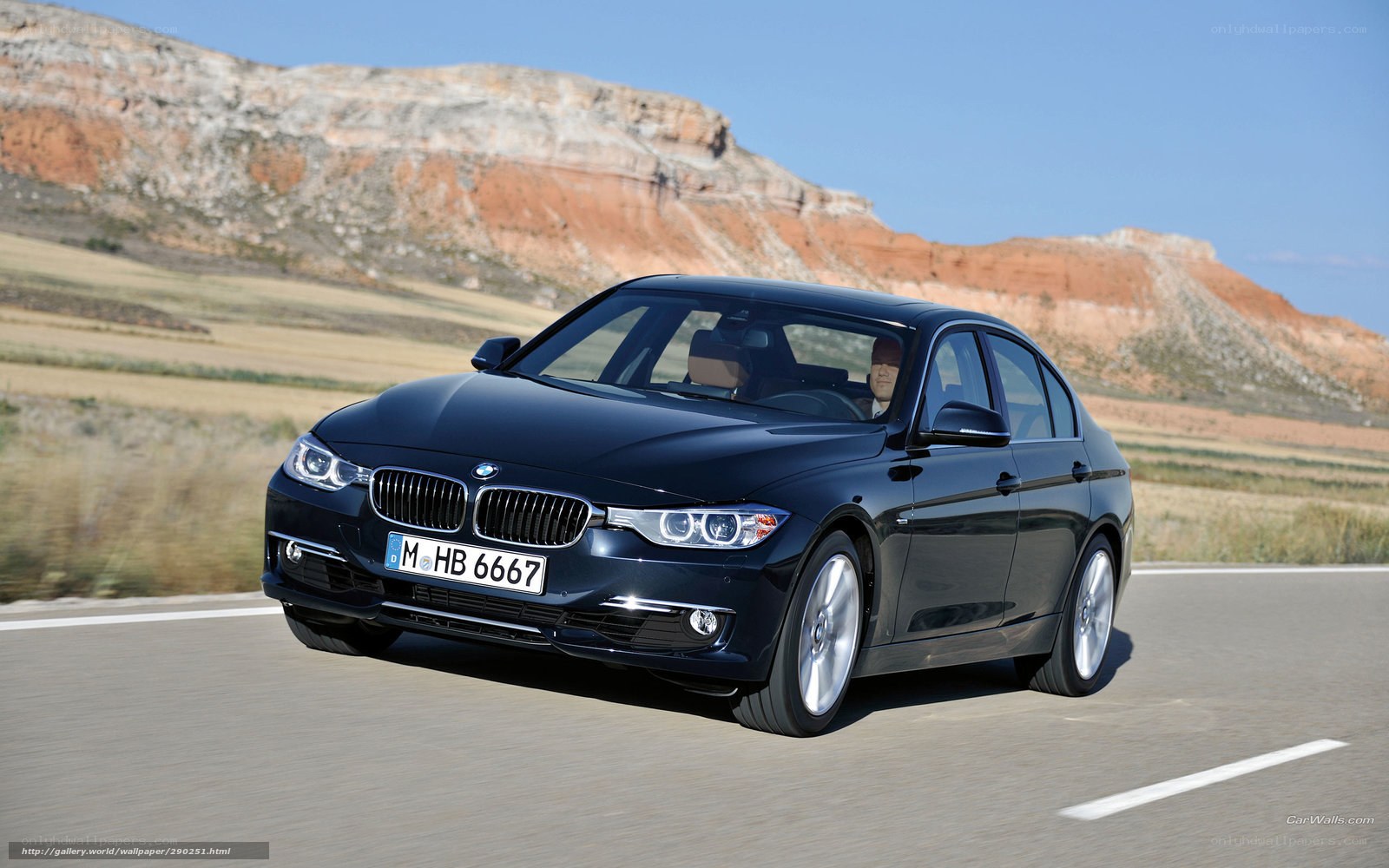 black bmw 3 series driving