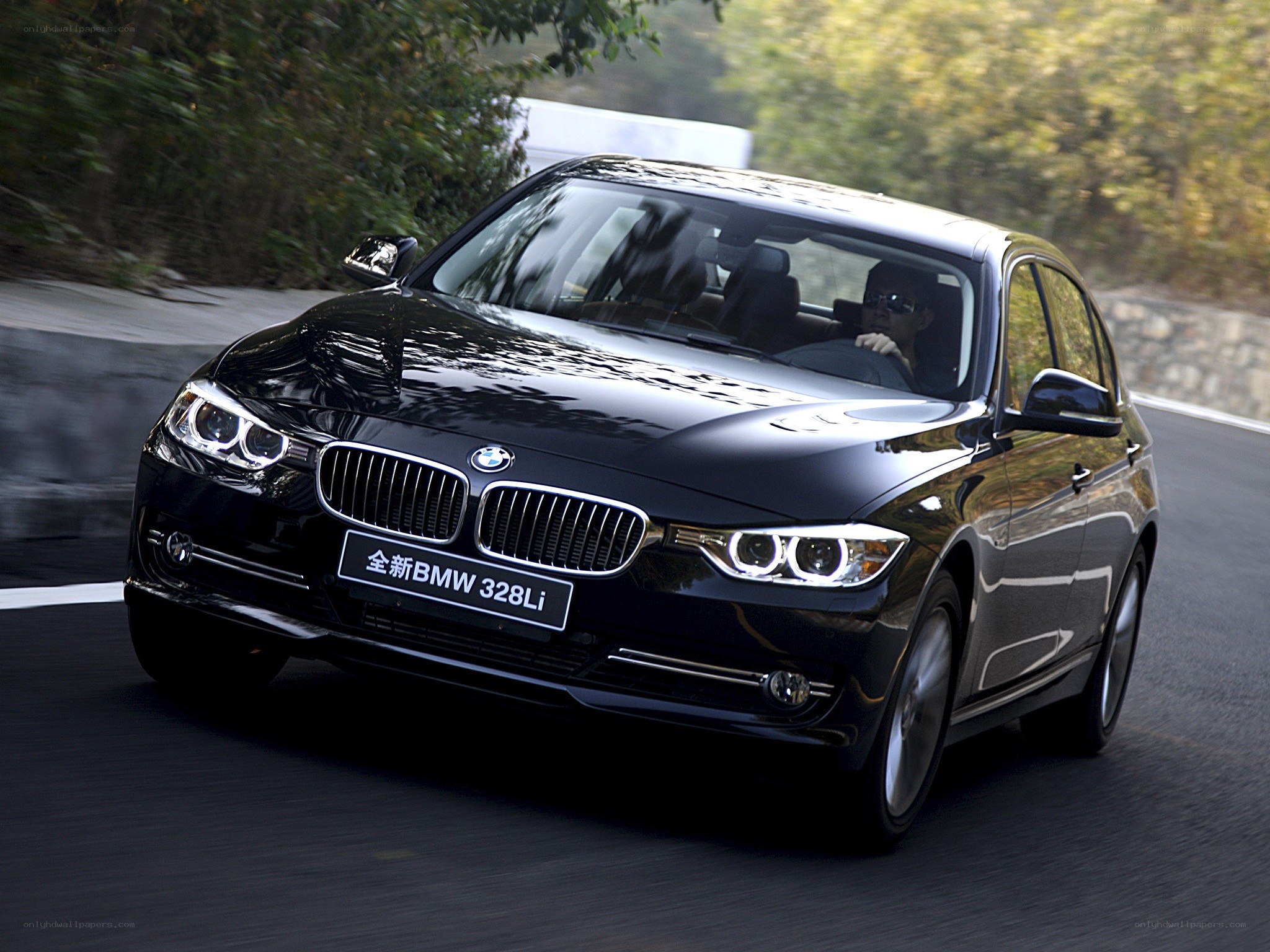 Black BMW 328Li in motion