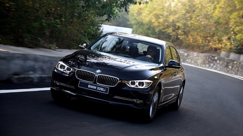 Black BMW 328Li on a winding road