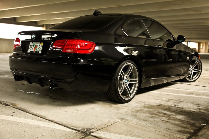 Black BMW 335is parked in garage