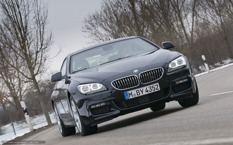 Black BMW 6 Series driving on road