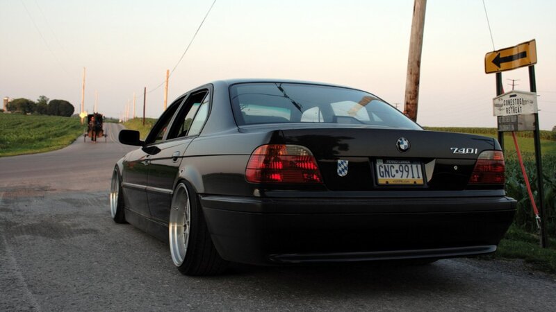 black bmw 740i on country road